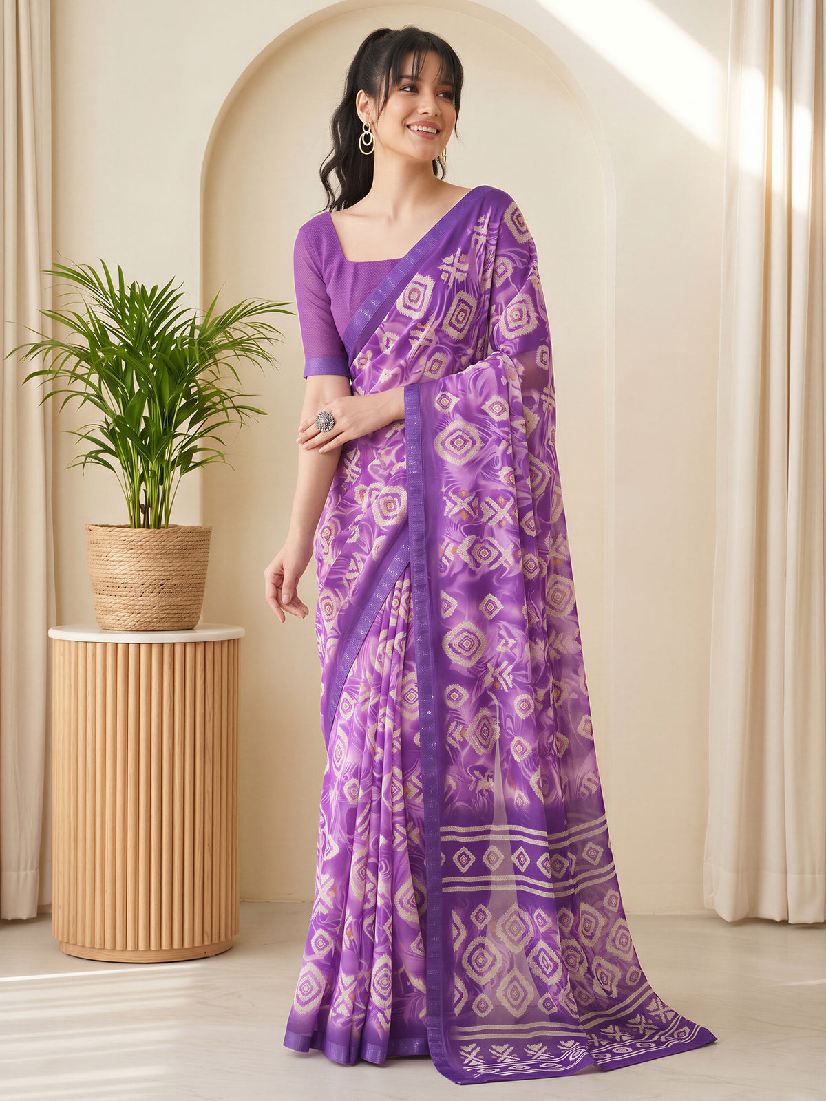 Woman wearing purple georgette saree with batik wax-resist design and purple blouse