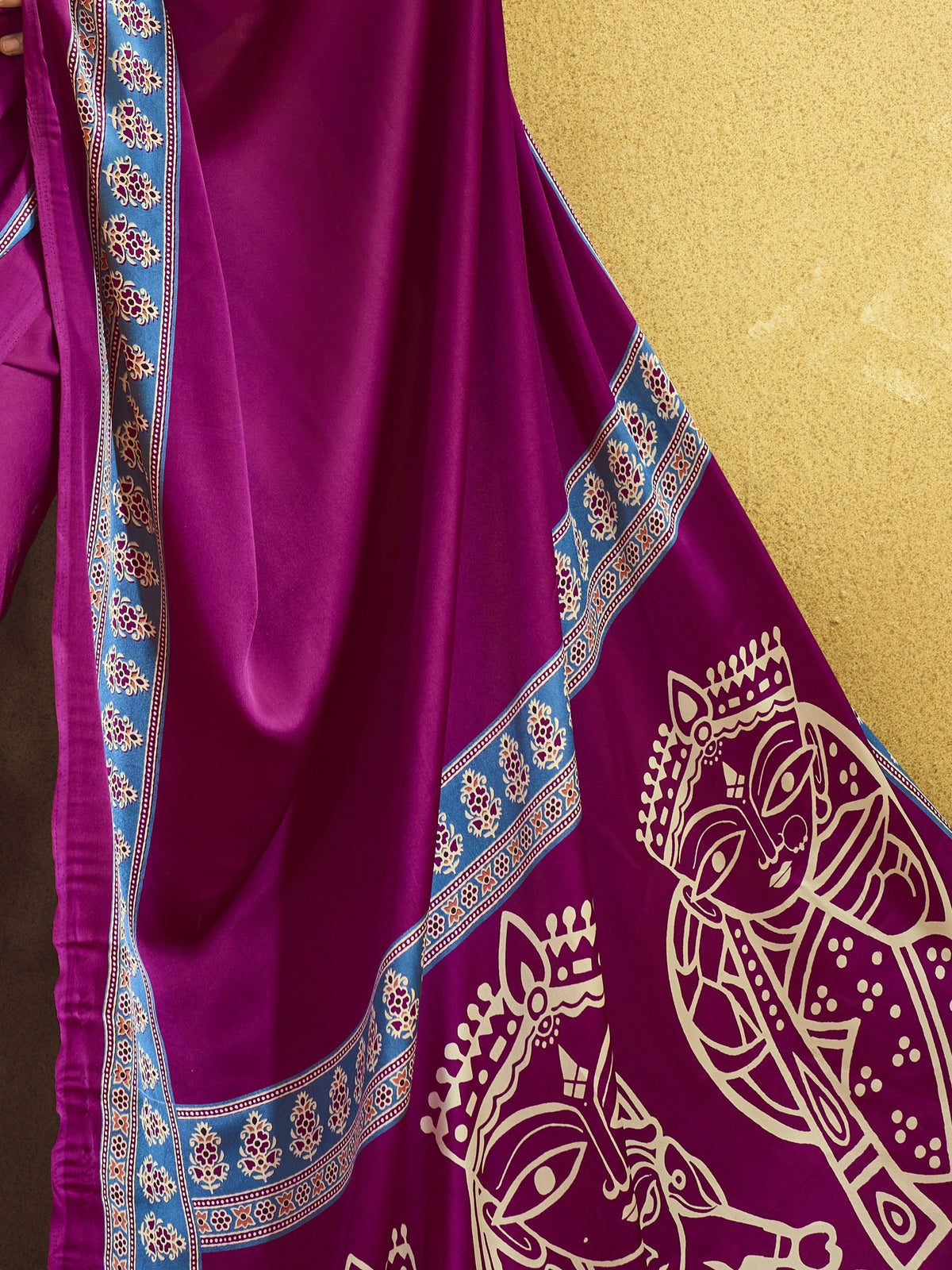 Pallu detail of magenta satin saree showing ajrak block-print motif work and printed border
