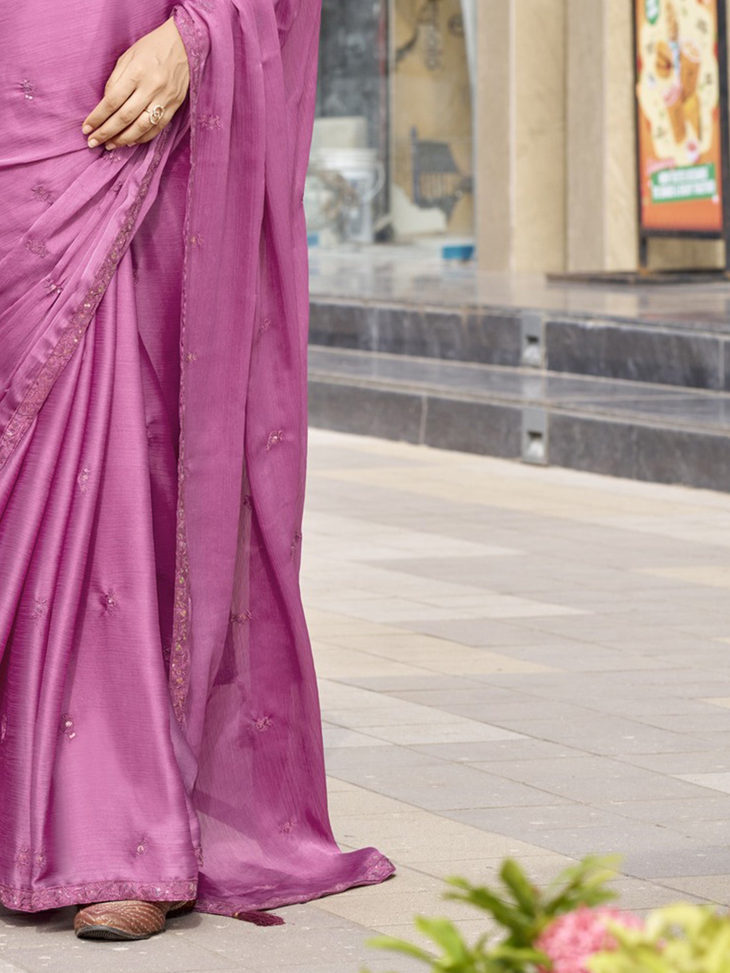 Pallu detail of mauve satin silk saree showing ornamented surface design and embellished border