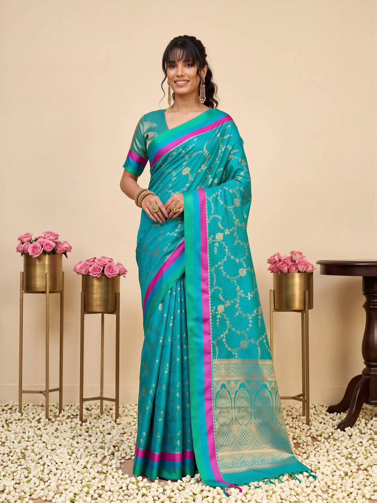 Woman wearing teal blue pure silk saree with traditional indian motif work and teal blue blouse