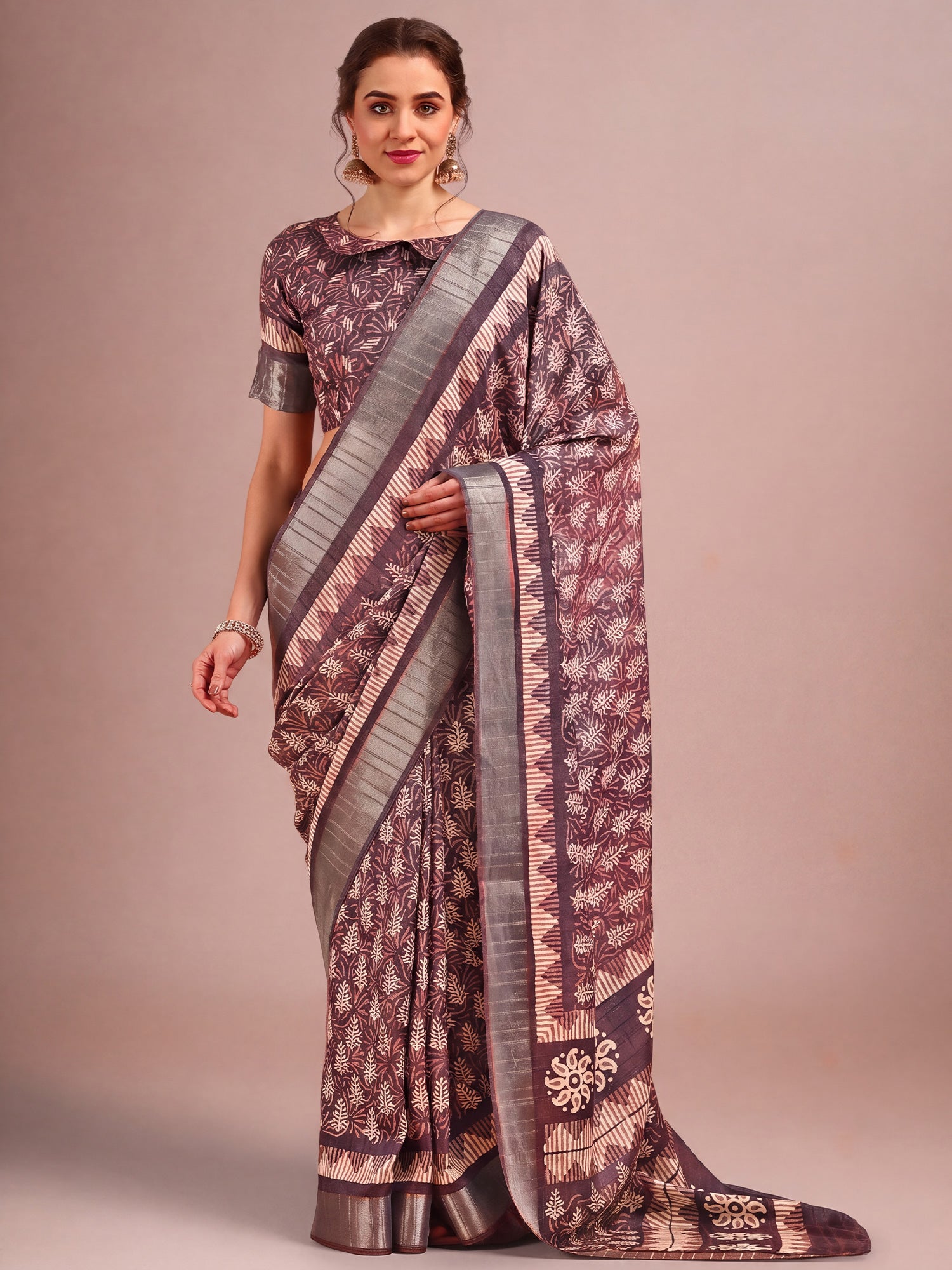 Woman wearing burgundy cotton silk saree with traditional indian motif work and burgundy blouse