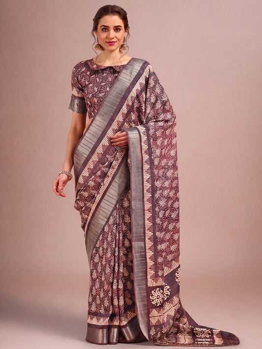 Woman wearing burgundy cotton silk saree with traditional indian motif work and burgundy blouse