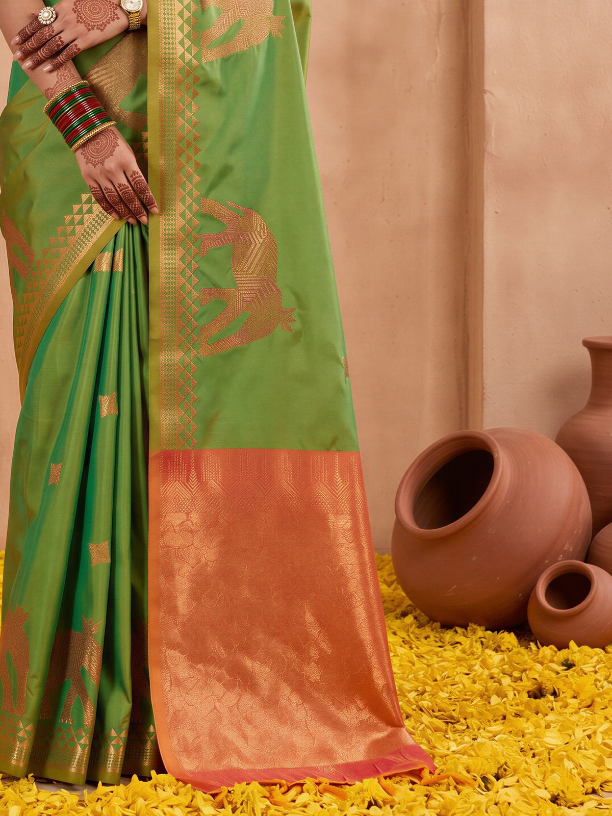 Pallu detail of green silk saree showing animal-print design and zari border