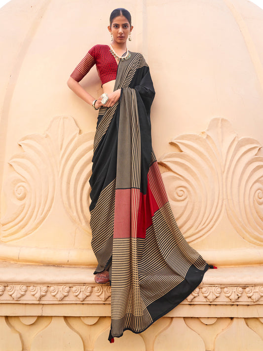 Woman wearing black silk blend saree with striped pattern design and red blouse