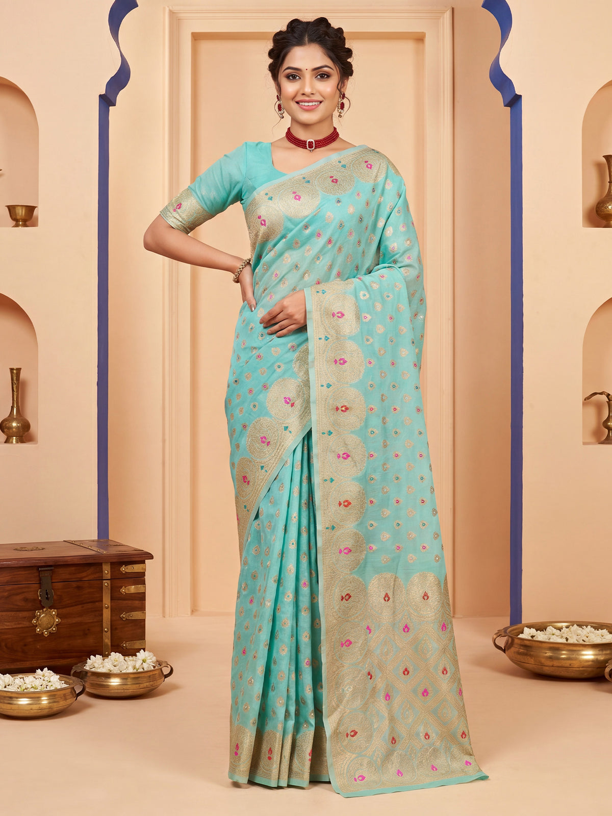 Woman wearing light blue silk blend saree with zari butta (metallic motif) work and light blue blouse