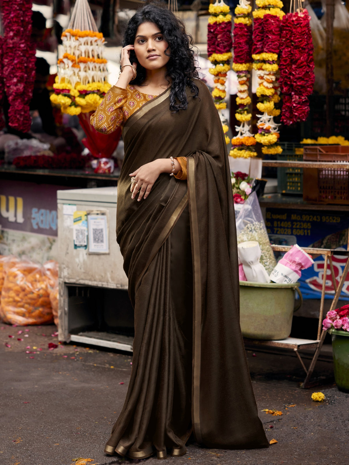 Woman wearing dark brown cotton blend saree with clean solid-tone finish and mustard blouse