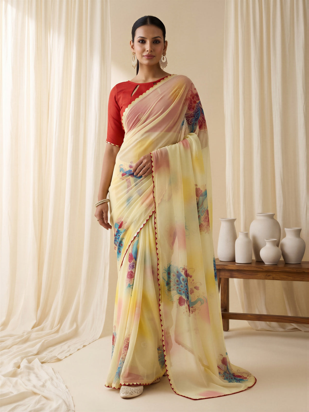Woman wearing yellow georgette saree with metallic foil print work and red blouse