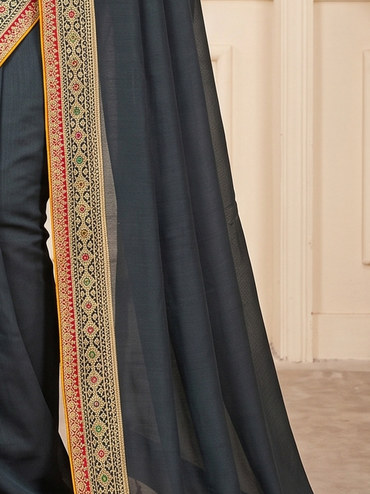 Pallu detail of green vichitra silk saree showing clean solid-tone finish and embellished border