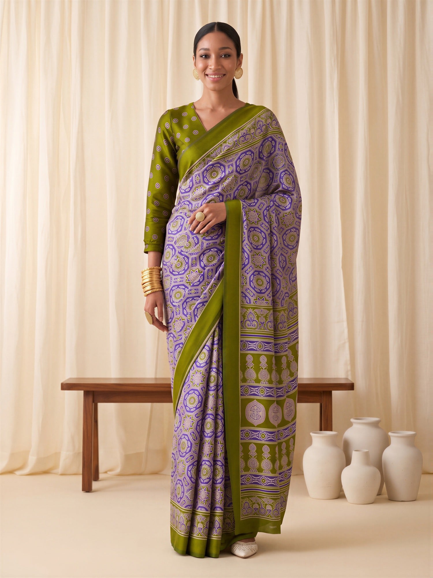 Woman wearing purple crepe saree with ajrak block-print motif work and olive blouse