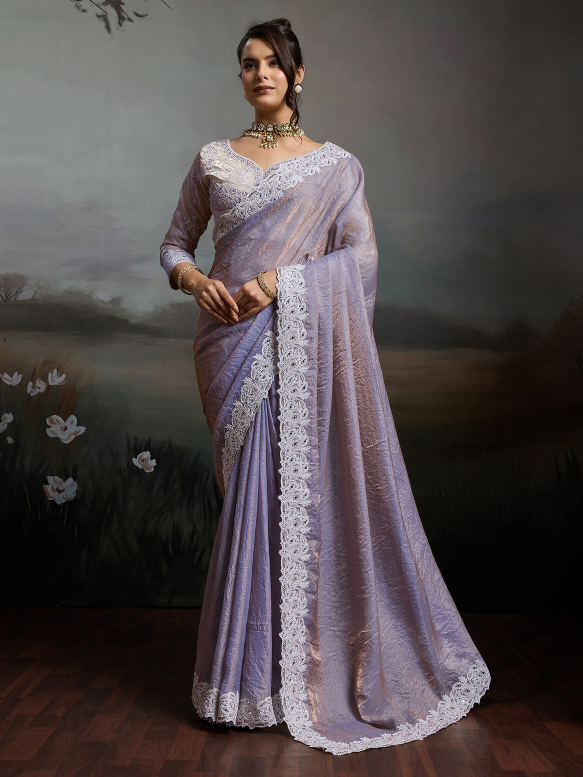 Woman wearing lavender satin silk saree with clean solid-tone finish and lavender blouse