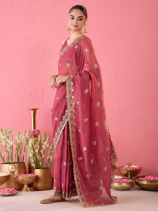 Woman wearing mauve tissue ready to wear saree with ornamented surface design and mauve blouse