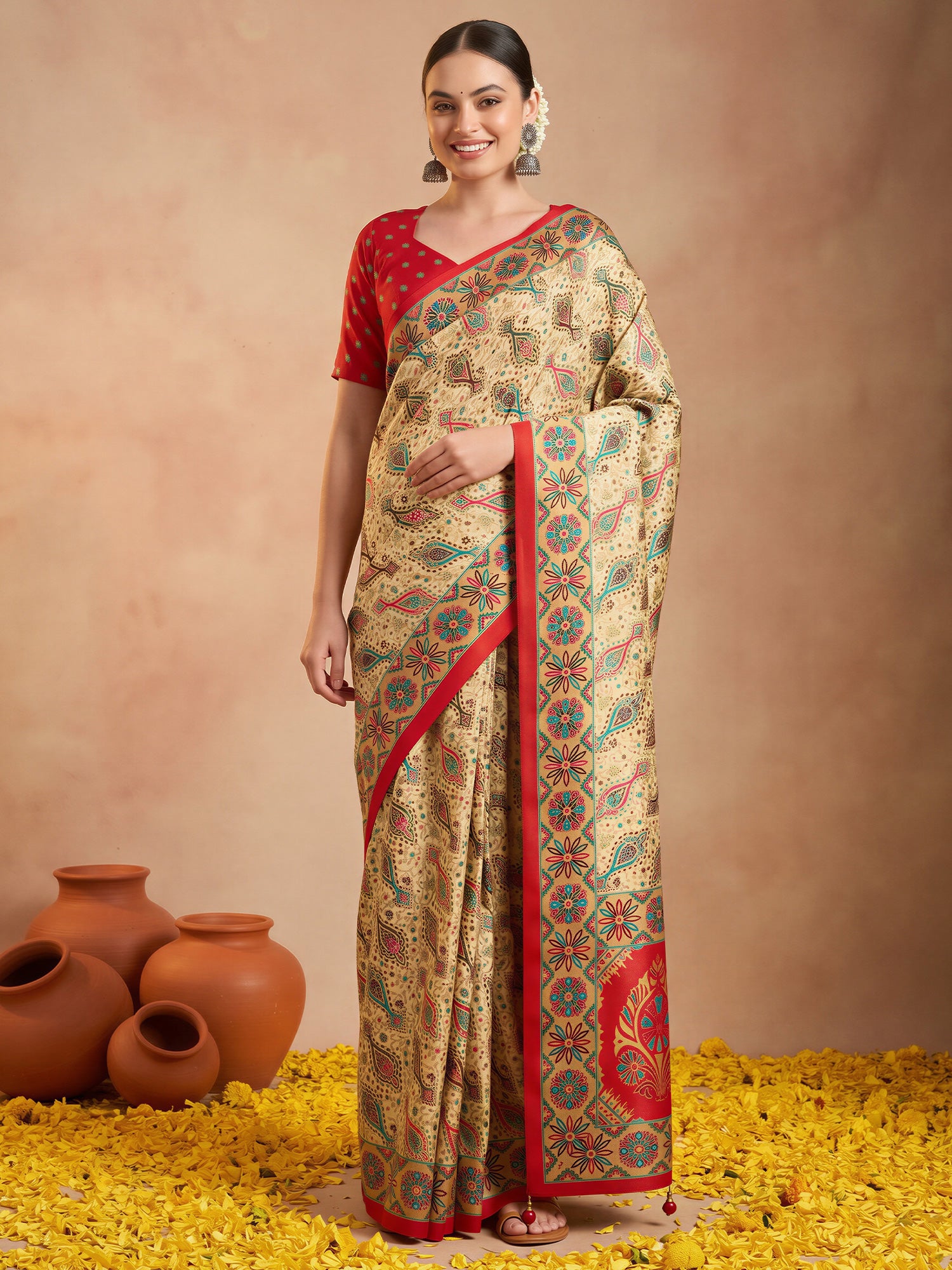 Woman wearing red silk blend saree with metallic foil print work and red blouse