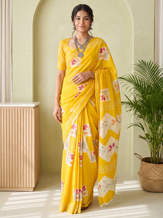 Woman wearing yellow cotton saree with traditional indian motif work and yellow blouse