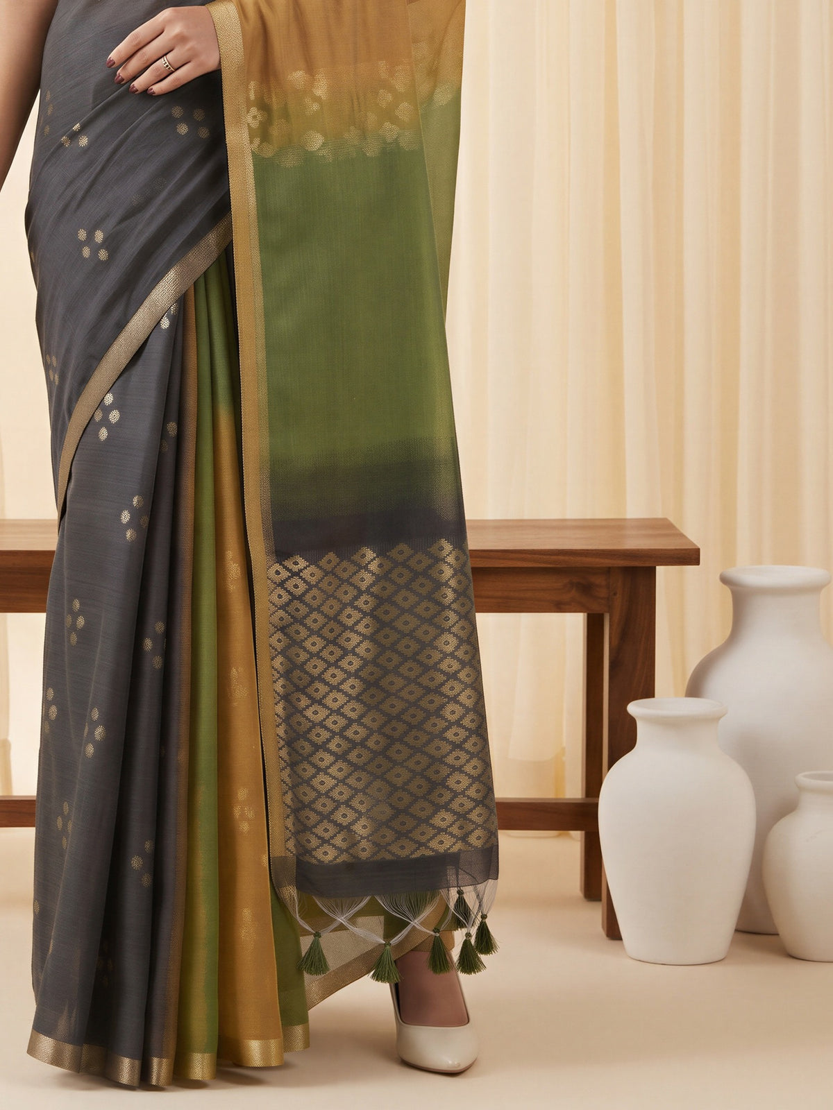 Pallu detail of mustard viscose silk saree showing traditional indian motif work and solid border