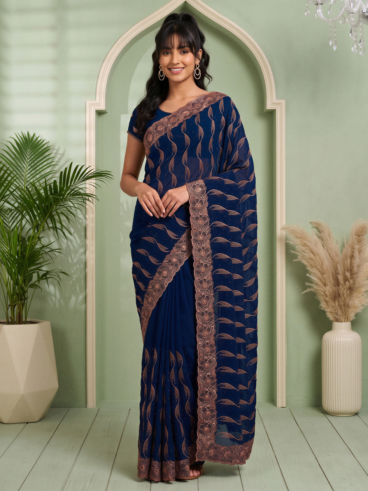 Woman wearing teal blue pure georgette saree with geometric pattern design and teal blue blouse
