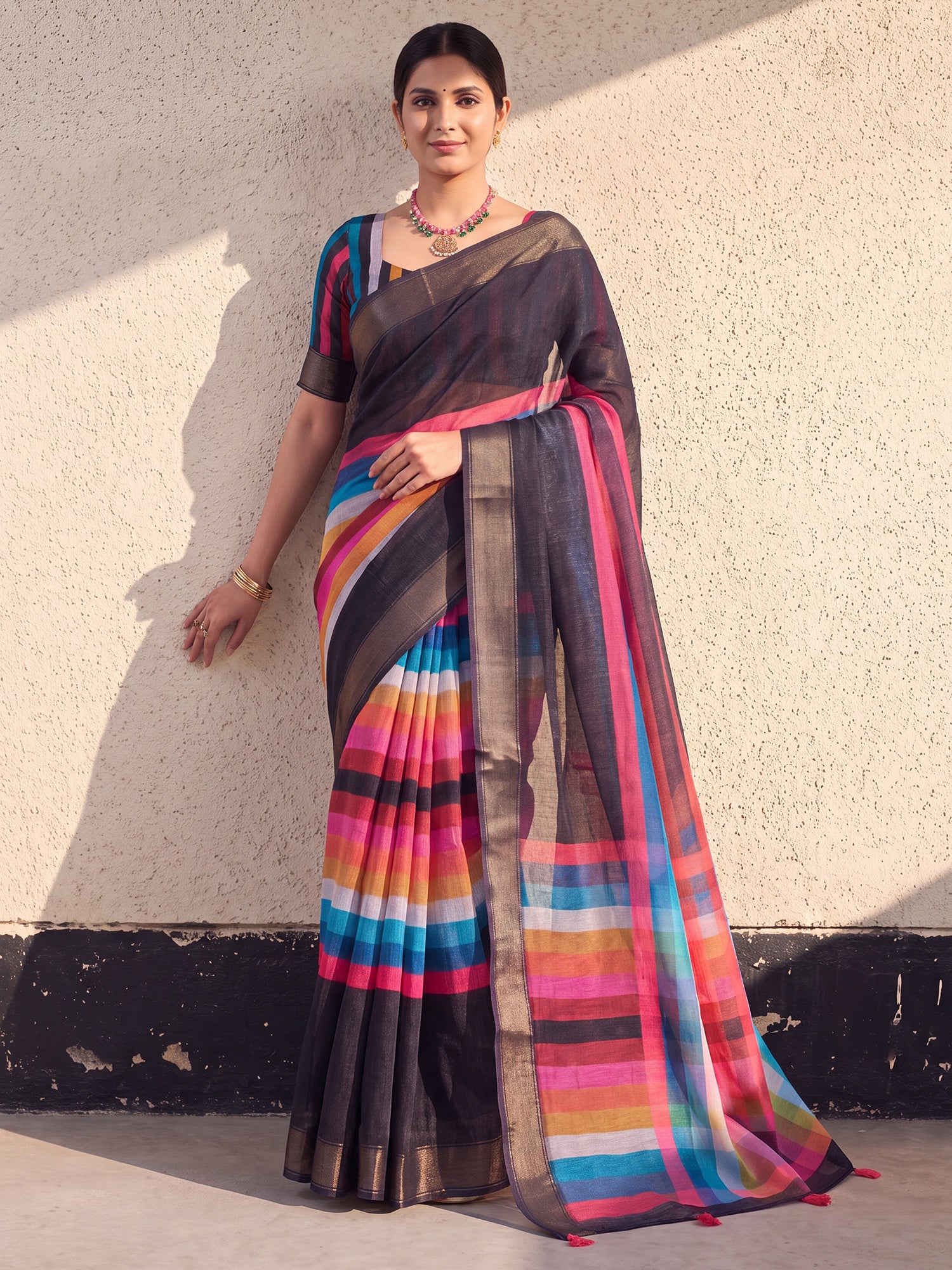 Woman wearing black linen saree with colorblocked design and multicolored blouse