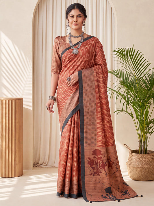 Woman wearing rust silk blend saree with geometric pattern design and rust blouse