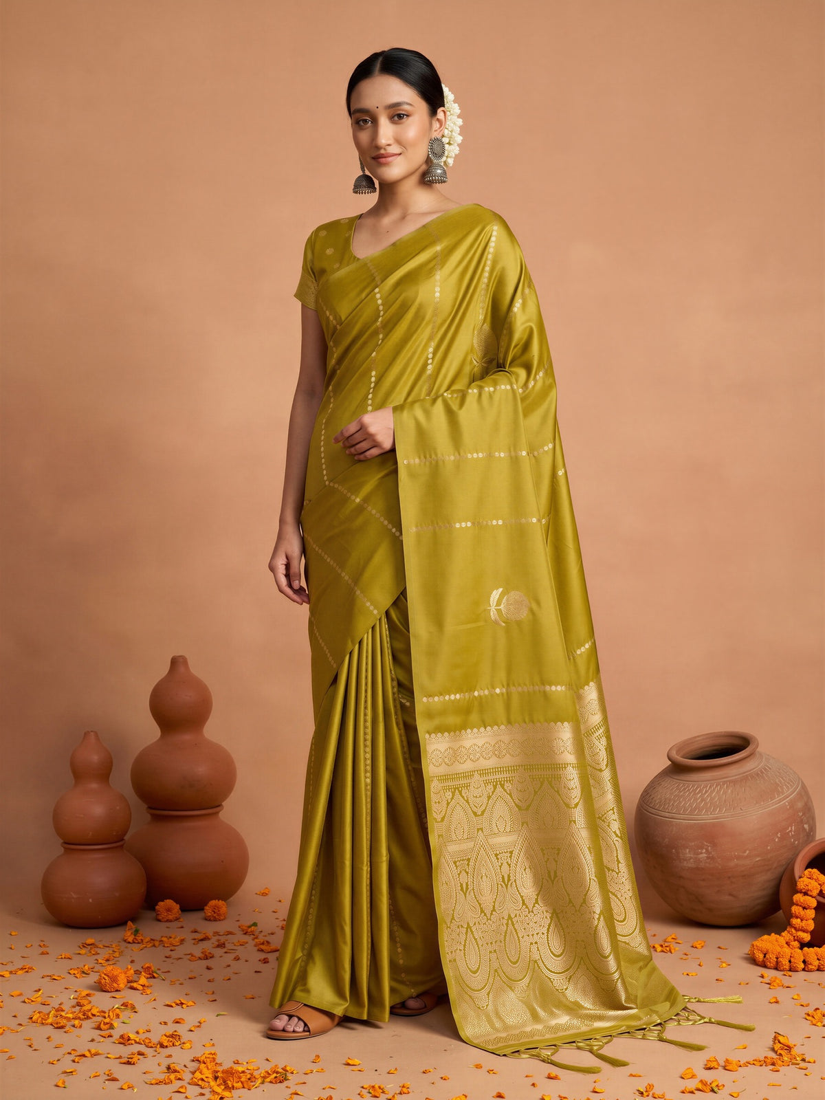 Woman wearing mustard satin silk saree with traditional indian motif work and mustard blouse
