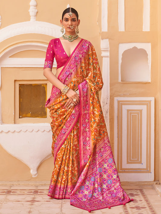 Woman wearing mustard silk blend saree with ikat resist-dyed pattern and pink blouse