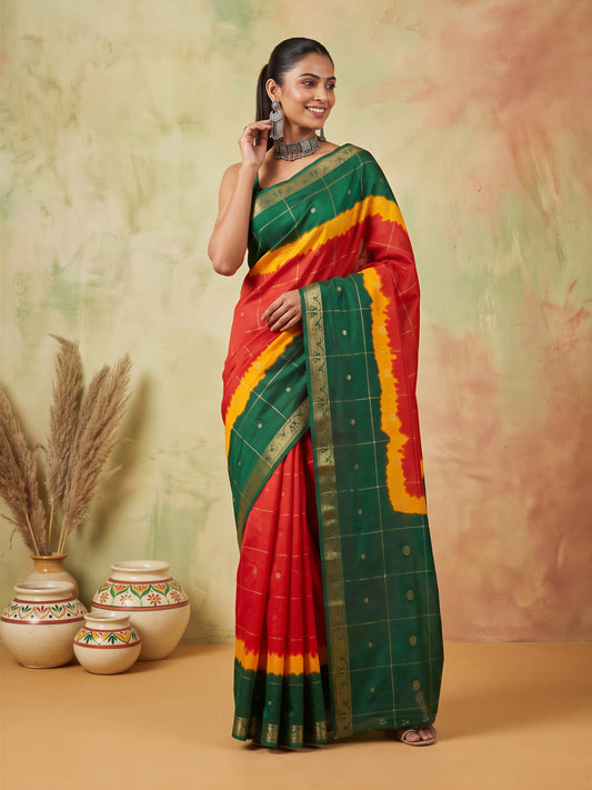 Woman wearing multicolored dola silk saree with zari butta (metallic motif) work and green blouse