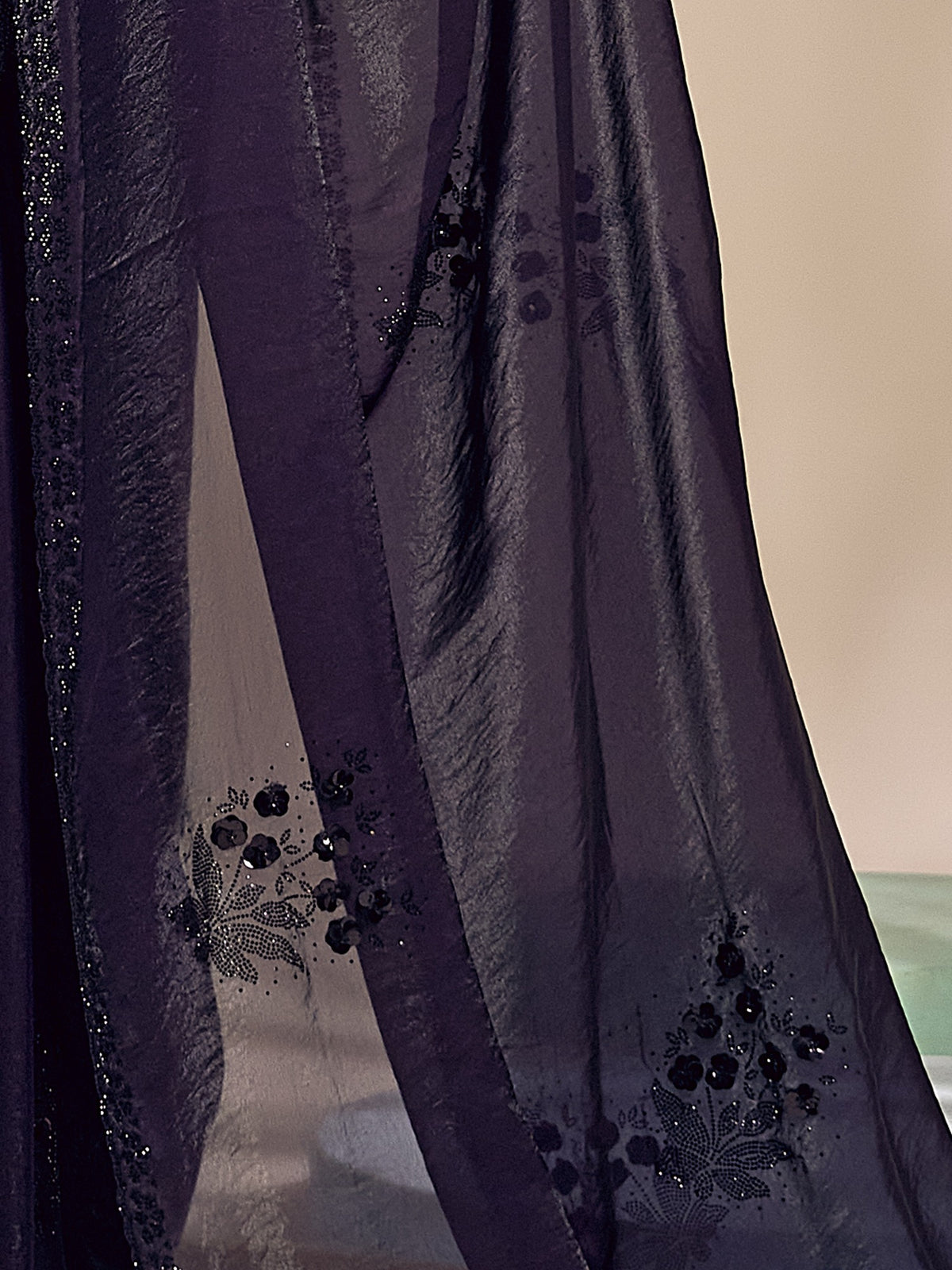 Pallu detail of purple satin silk saree showing ornamented surface design and scallop border
