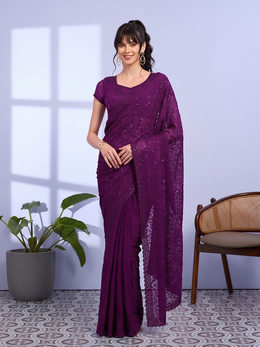 Woman wearing purple tissue saree with ornamented surface design and purple blouse