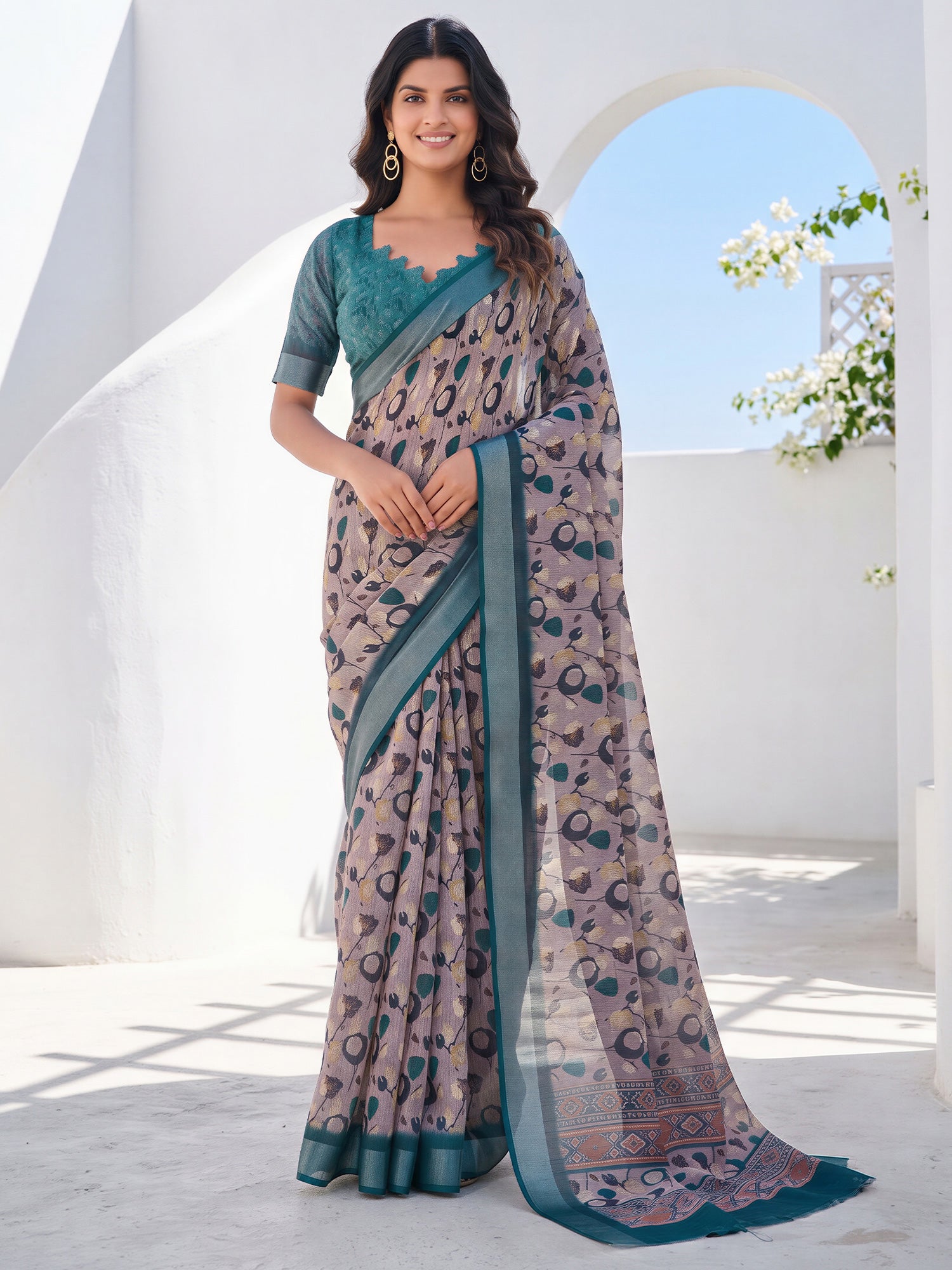 Woman wearing taupe cotton linen saree with traditional indian motif work and teal blue blouse
