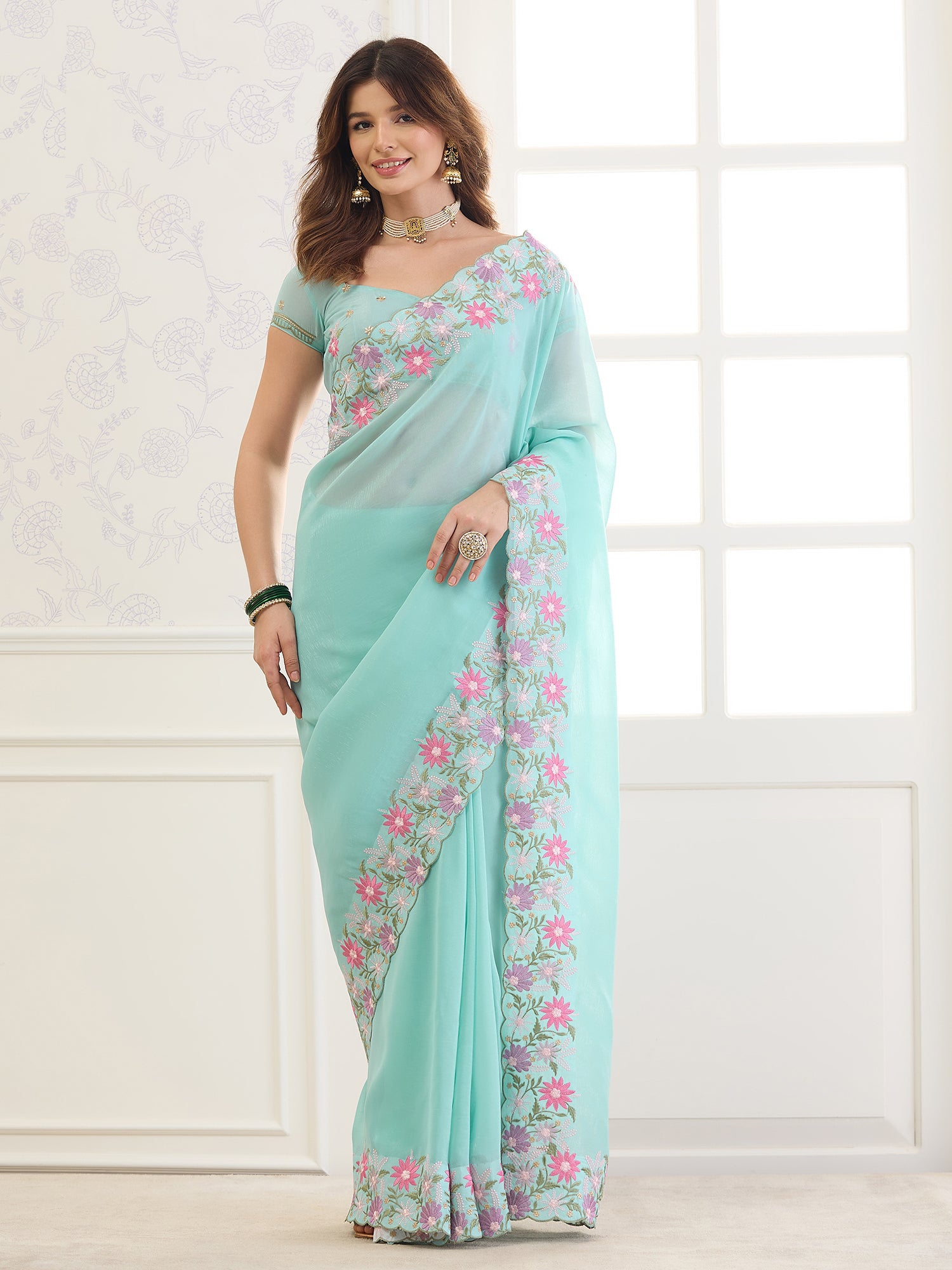 Woman wearing aqua blue georgette saree with clean solid-tone finish and aqua blue blouse