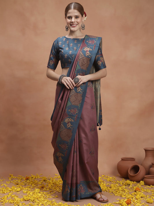Woman wearing mauve silk blend saree with traditional indian motif work and teal blue blouse