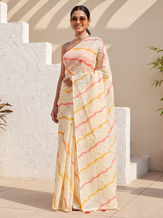 Woman wearing cream cotton linen saree with geometric pattern design and rust blouse