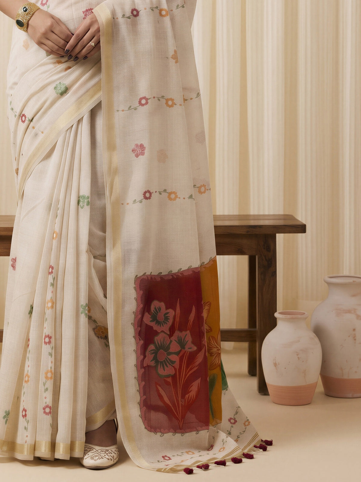 Pallu detail of off white cotton blend saree showing traditional indian motif work and zari border