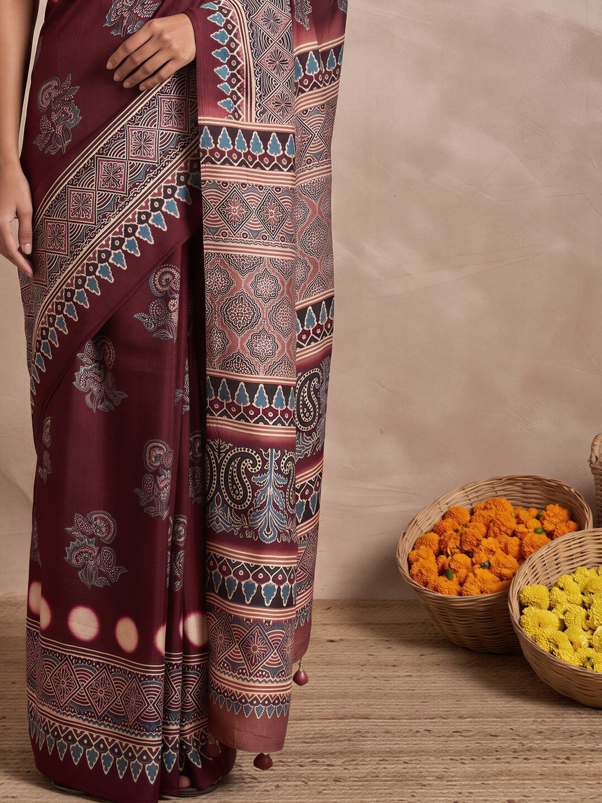 Pallu detail of maroon viscose silk saree showing ajrak block-print motif work and printed border