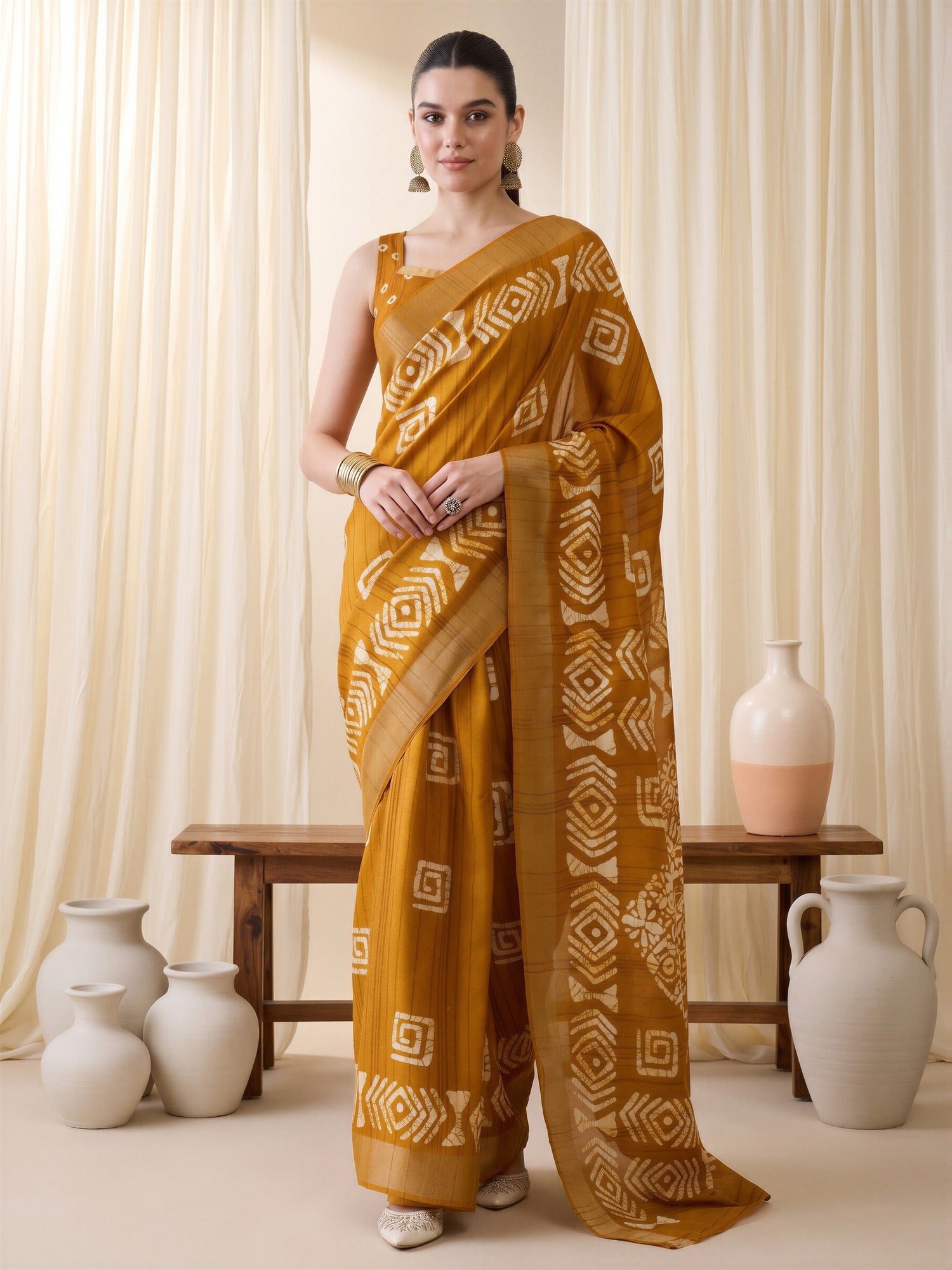 Woman wearing mustard silk blend saree with traditional indian motif work and mustard blouse