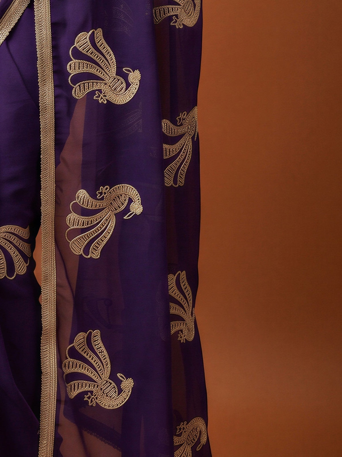 Pallu detail of purple georgette saree showing embroidered motif work and embellished border