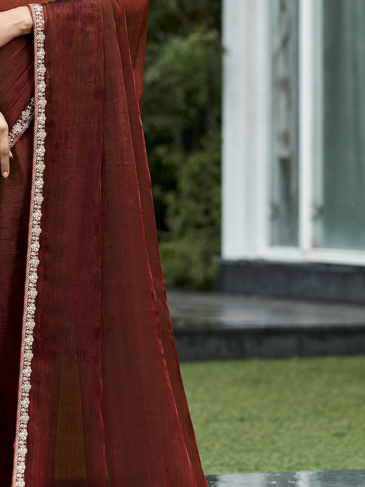 Pallu detail of brown chiffon saree showing clean solid-tone finish and embellished border
