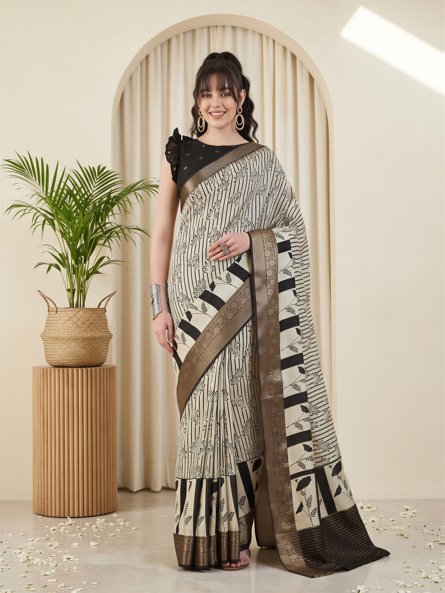 Woman wearing off white viscose silk saree with striped pattern design and black blouse