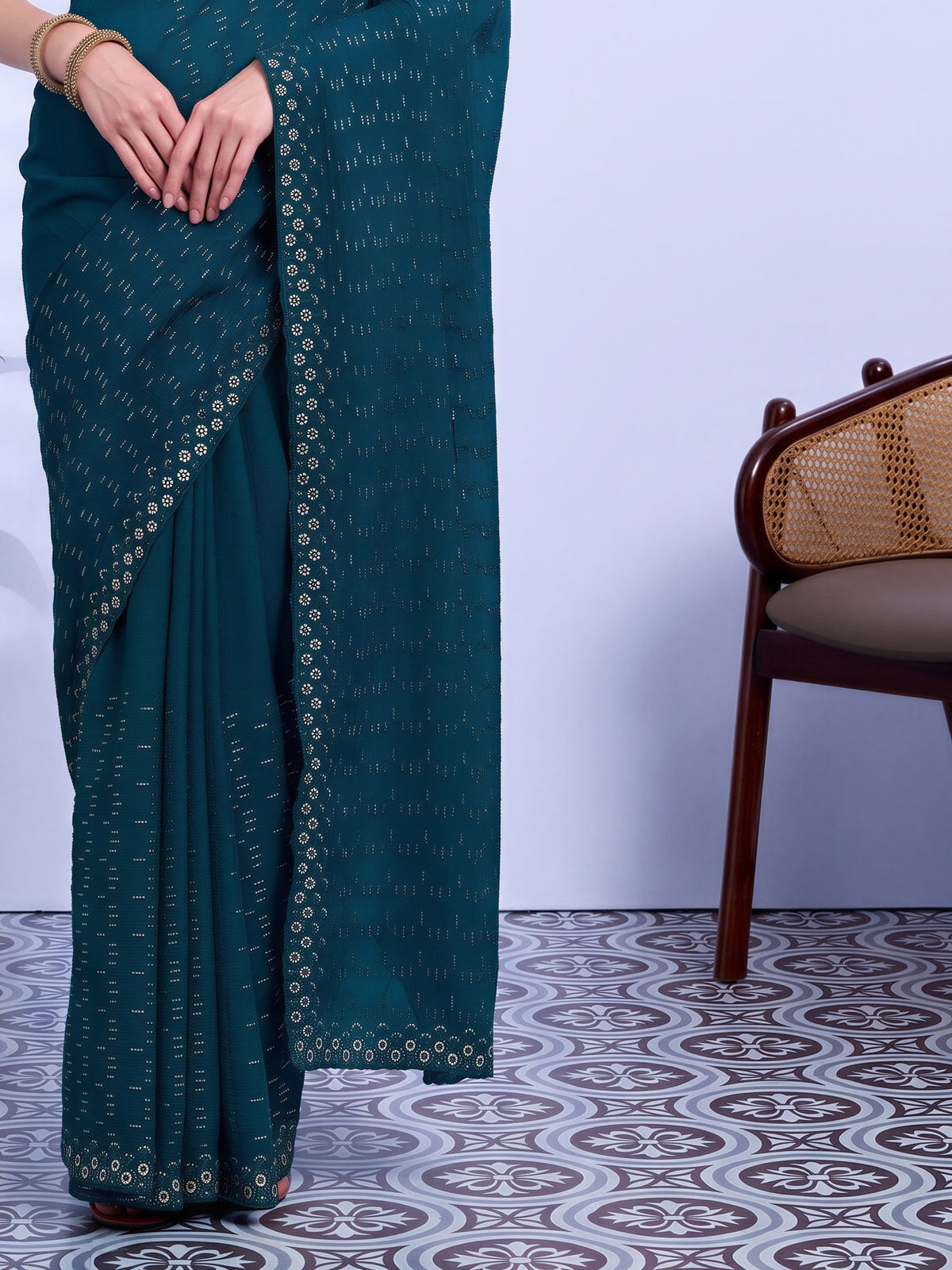 Pallu detail of off white tissue saree showing ornamented surface design and embellished border