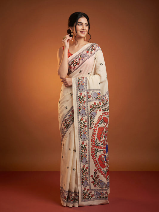 Woman wearing off white chinnon saree with kalamkari narrative motif work and coral blouse