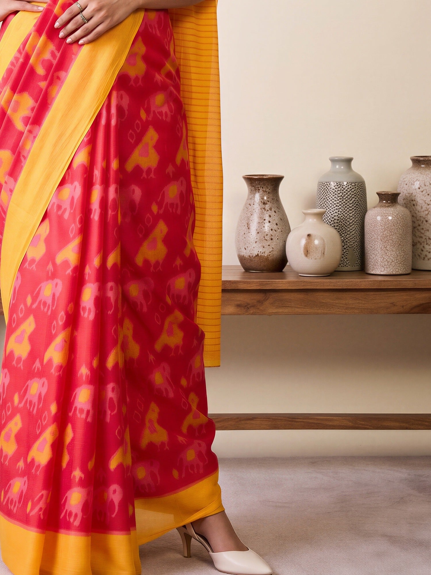 Pallu detail of pink cotton blend saree showing animal-print design and printed border
