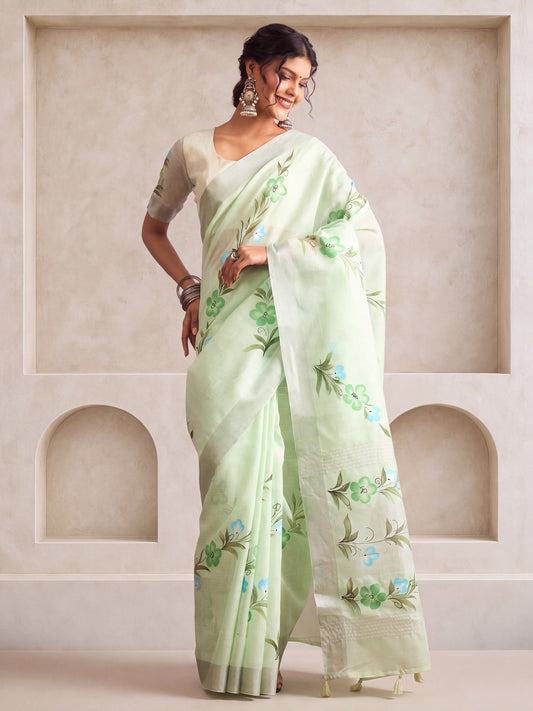 Woman wearing turquoise linen saree with traditional indian motif work and turquoise blouse