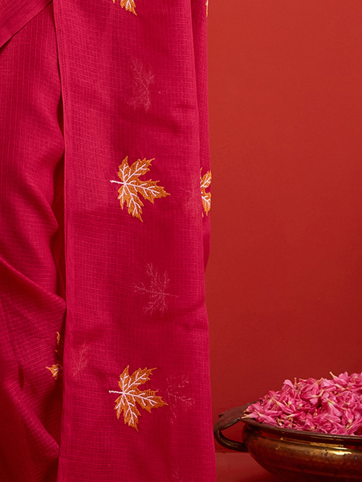 Pallu detail of maroon kota doria cotton saree showing embroidered motif work and solid border