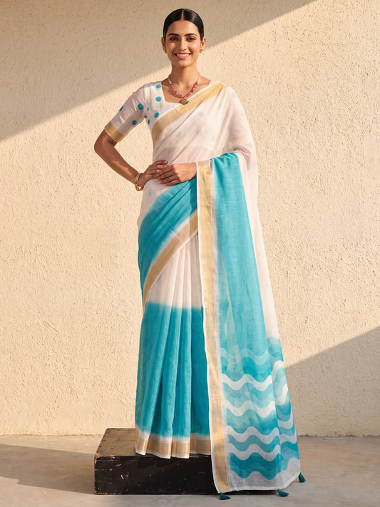 Woman wearing light blue linen saree with ombre graded colour work and white blouse