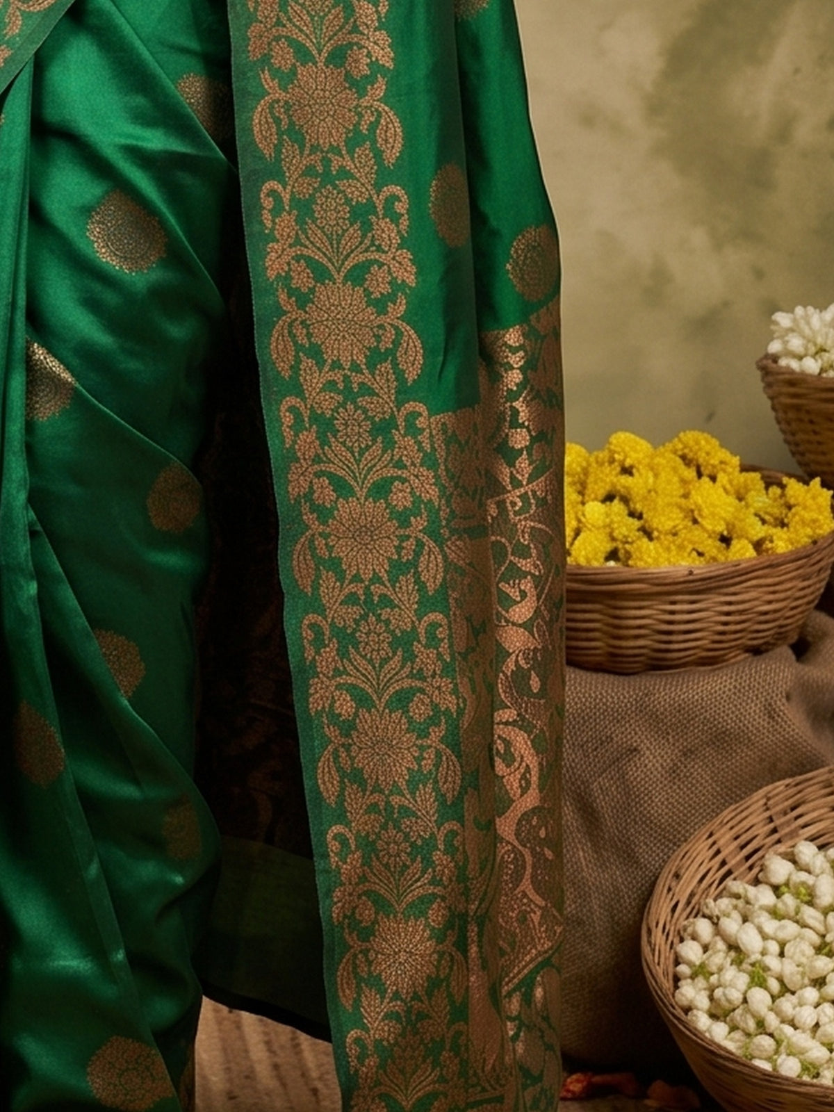 Pallu detail of green silk blend saree showing zari butta (metallic motif) work and zari border