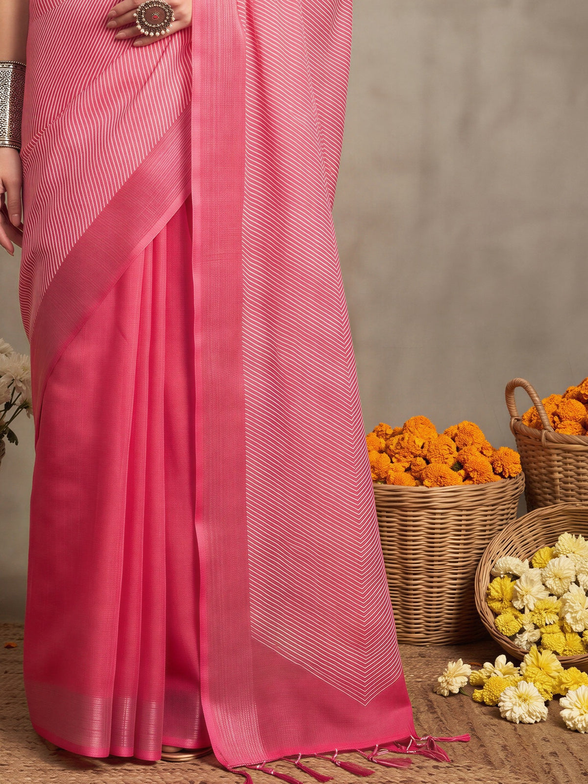 Pallu detail of pink linen saree showing striped pattern design and zari border