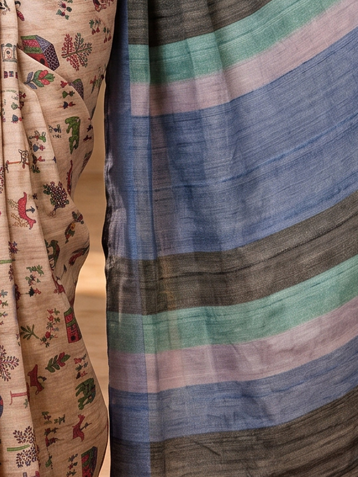 Pallu detail of beige soft silk saree showing tribal folk-art motifs and printed border