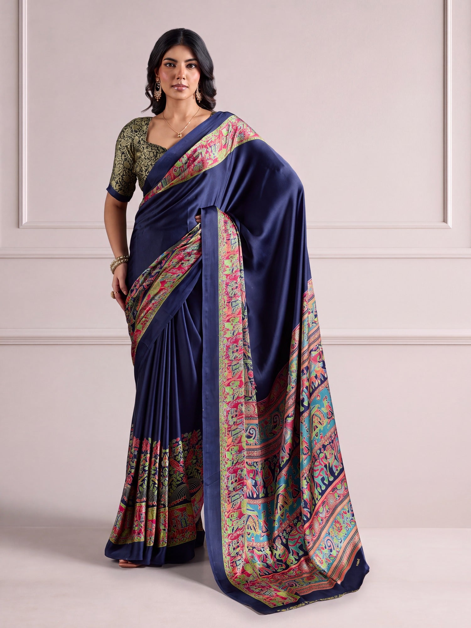Woman wearing navy blue satin saree with madhubani folk-art motifs and navy blue blouse