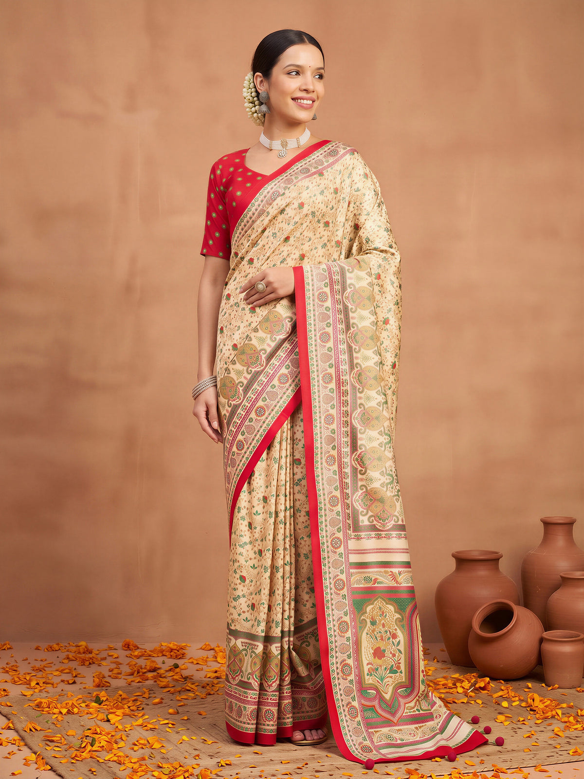 Woman wearing cream silk blend saree with metallic foil print work and pink blouse