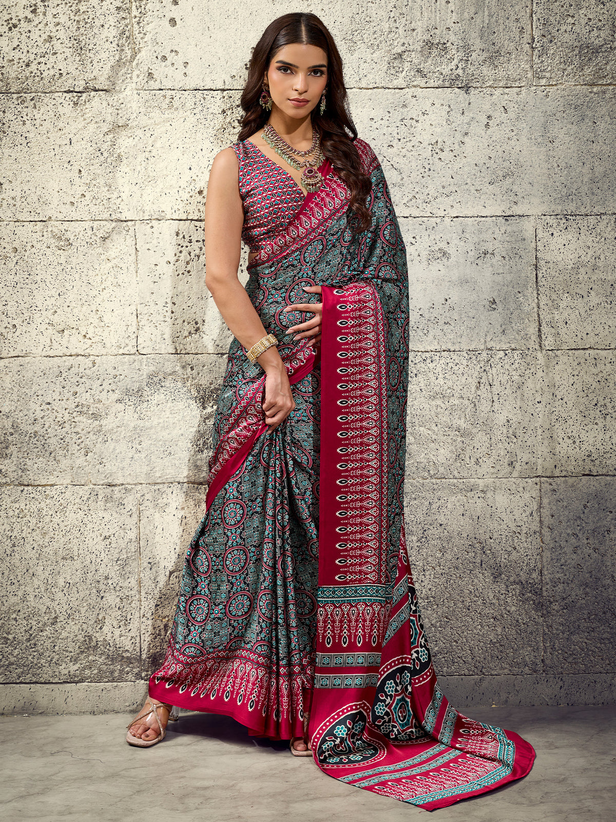Woman wearing maroon satin saree with ajrak block-print motif work and maroon blouse
