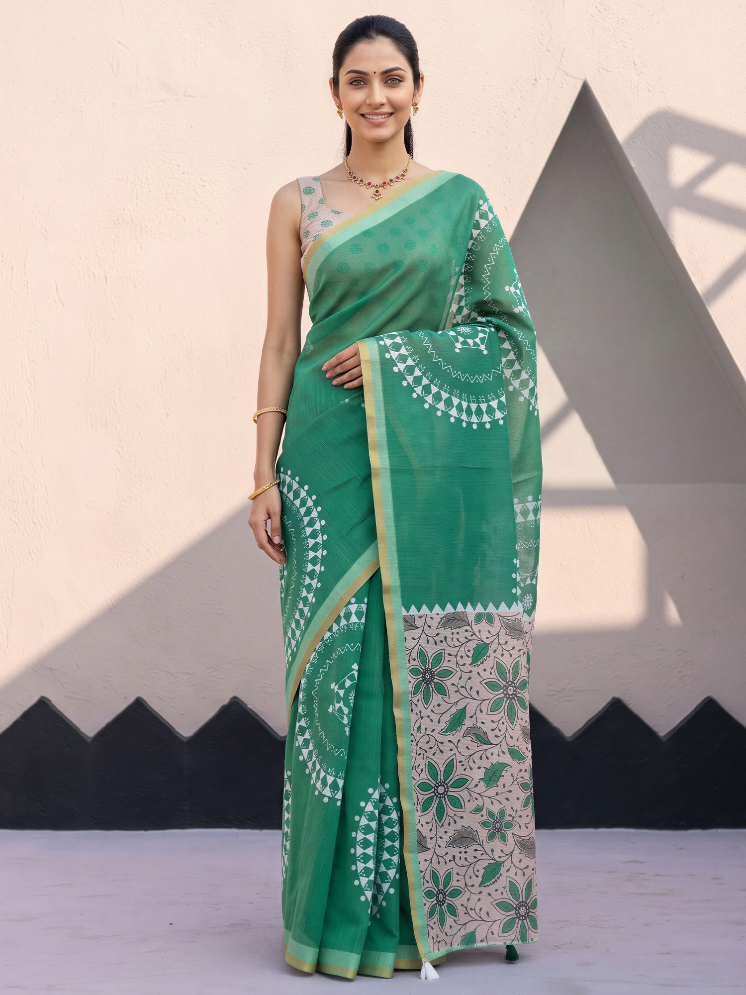 Woman wearing light green cotton blend saree with warli folk-art figures and peach blouse