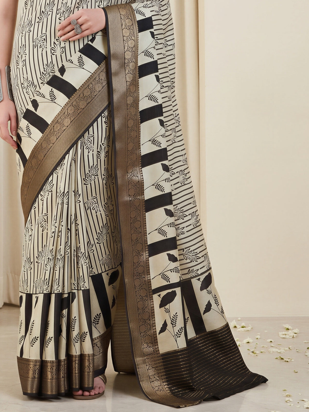 Pallu detail of off white viscose silk saree showing striped pattern design and zari border